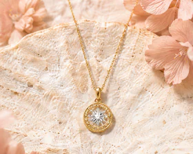 Gold pendant necklace styled with soft flowers