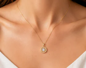Model wearing a delicate gold pendant necklace